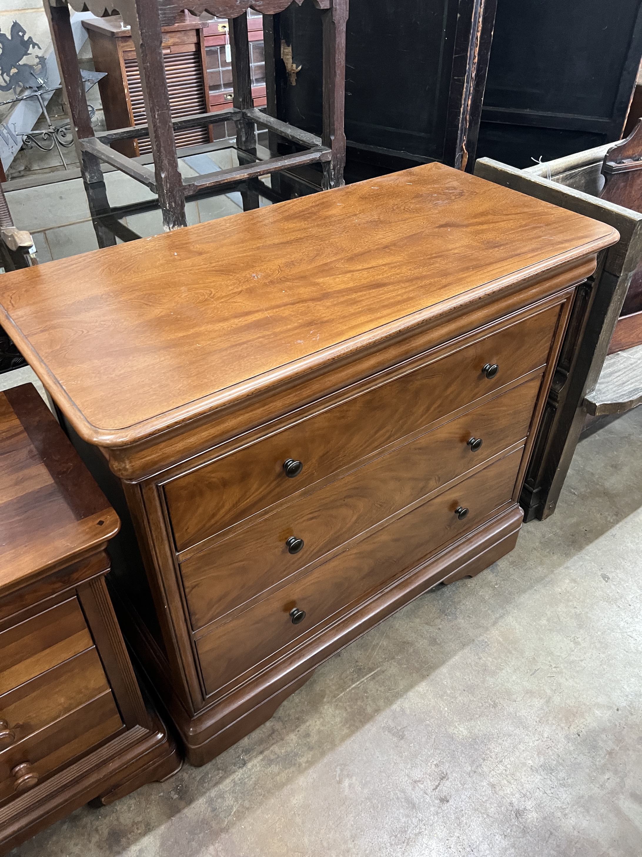 A contemporary five piece French mahogany bedroom suite, comprising sleigh bed, width 190cm, length 220cm, height 102cm (missing some bolts), a six drawer tall chest, three drawer chest and a pair of bedside chests